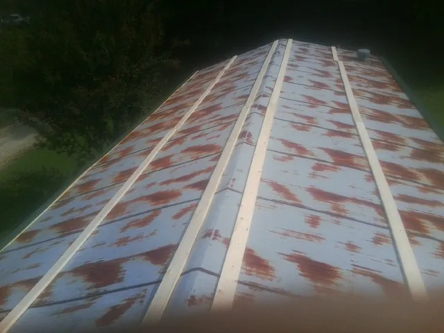 Rusted metal roof panels with new wood purlins before replacement — Storm Damage Roof Repair in Mountain Lakes by Roofing Brothers