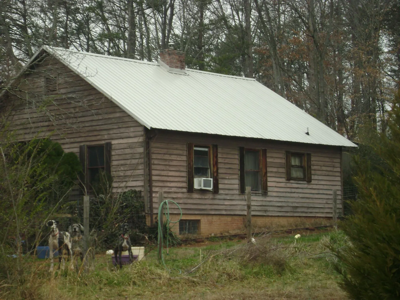 White metal roof on an old wood sided farmhouse, from a Asphalt Shingle Roof Repair job in Mountain Lakes